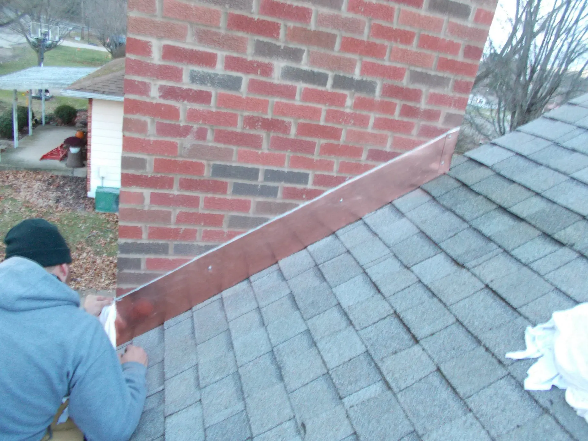 Worker installing chimney roof flashing