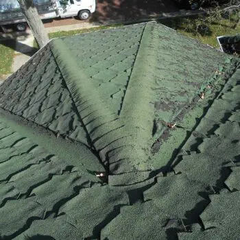 Damaged green shingle roofing repair